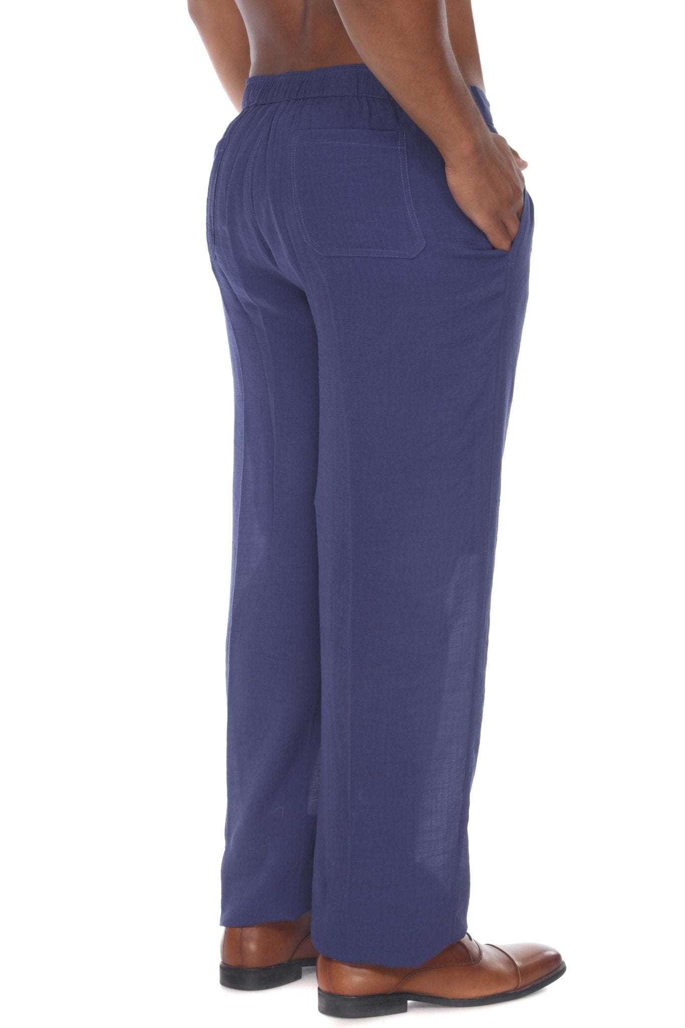 Rear view of blue men's Casual Drawstring Beach Pants; hand in pocket.