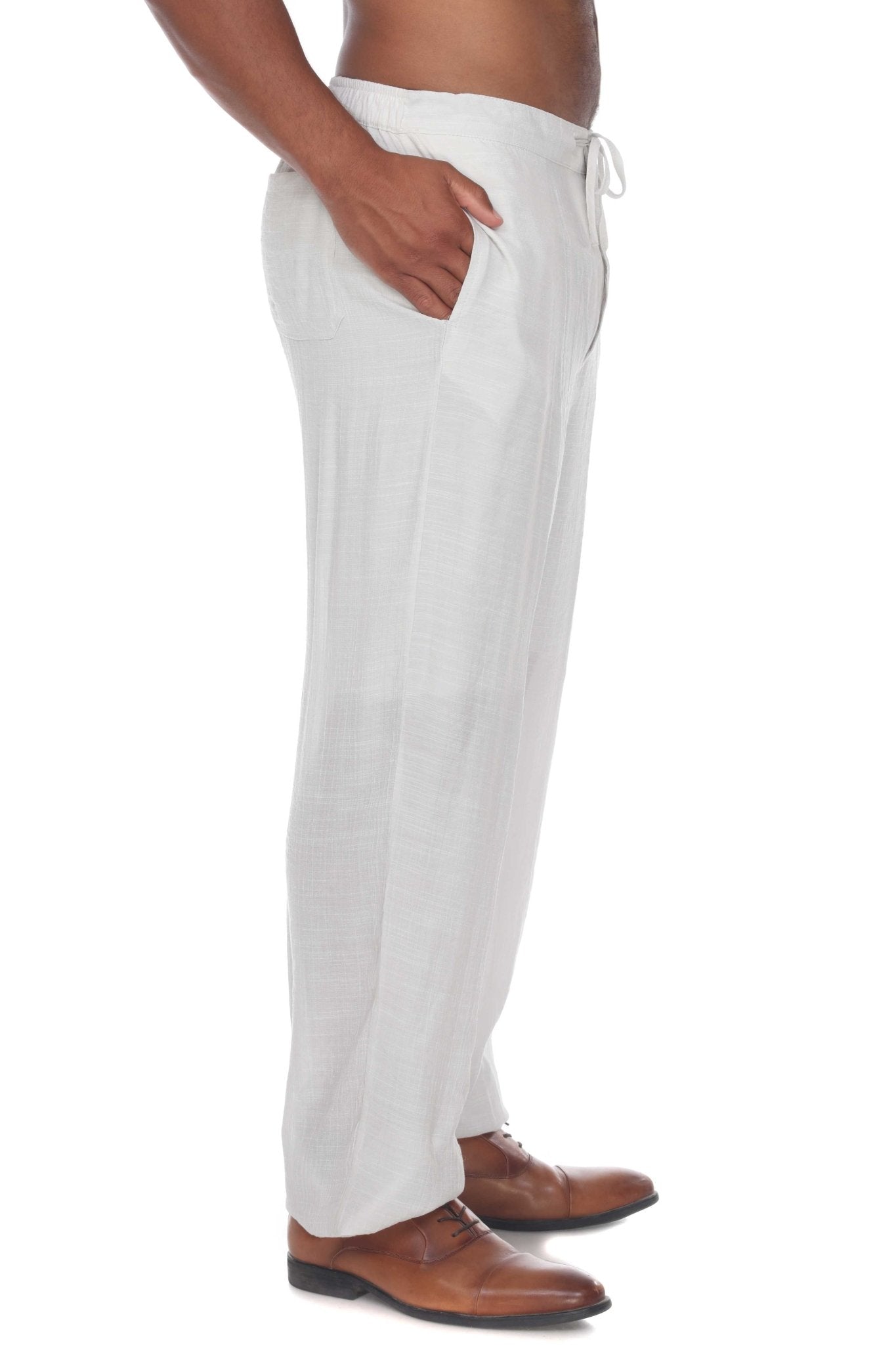 Side view of a person wearing white Men’s Casual Drawstring Beach Pants with a hand in the pocket.