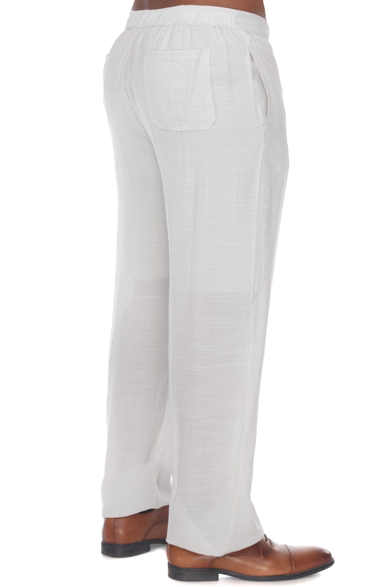 Side view of Men’s Casual Drawstring Beach Pants in white, showing back pocket and brown dress shoes.