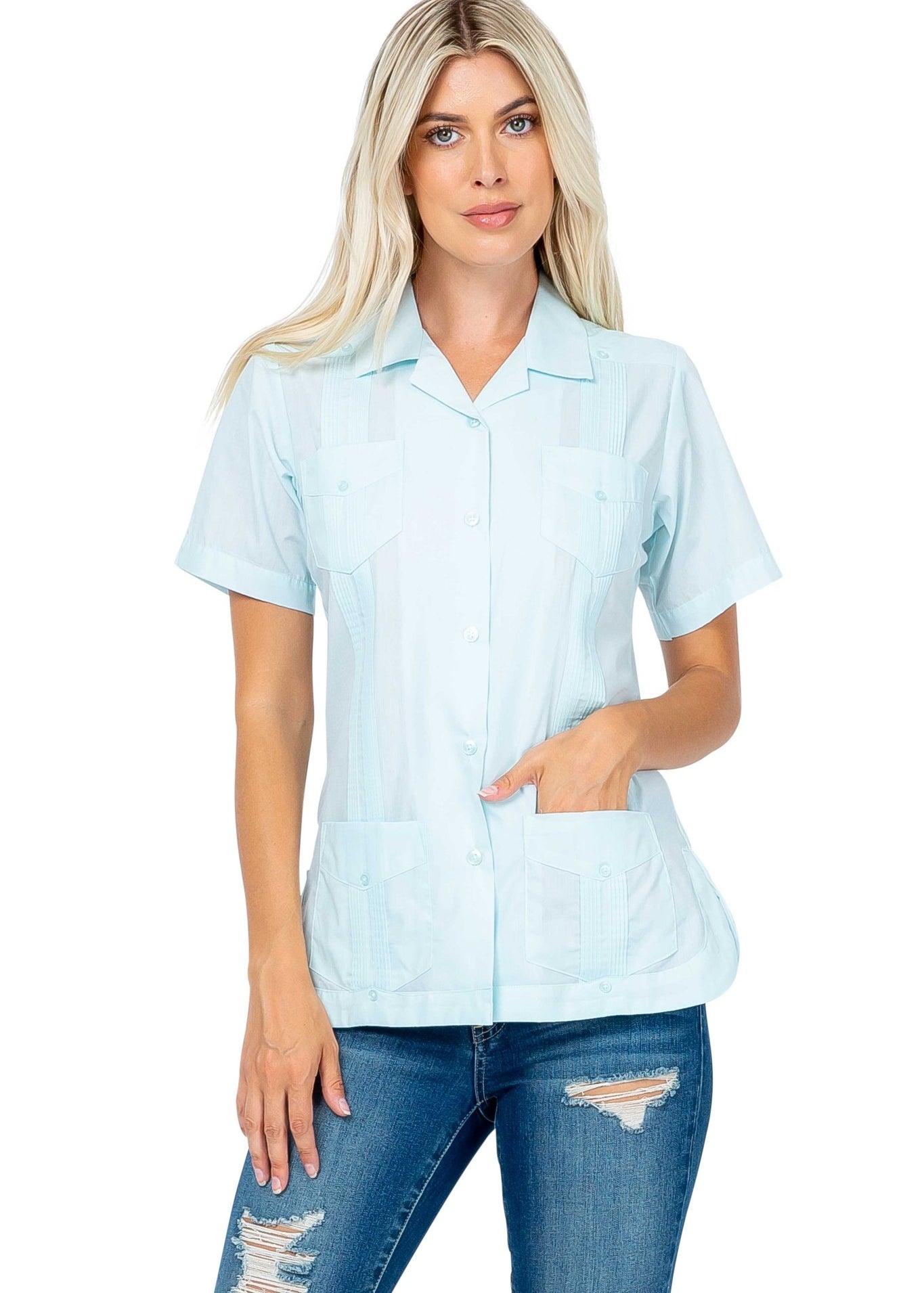 Front view of a light blue Women's Short Sleeve Guayabera with 4 Pockets on a model.