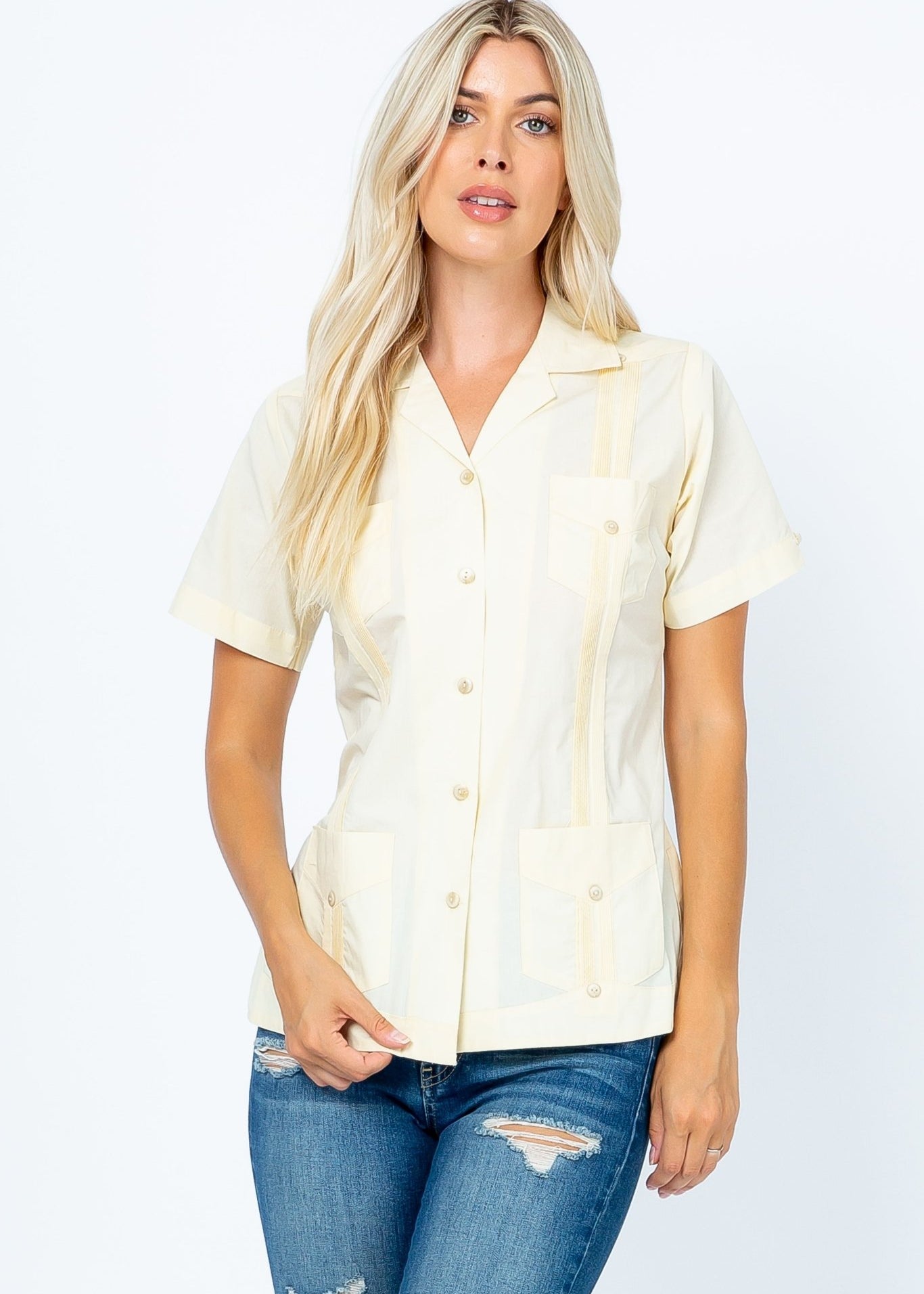 Front view of a blonde woman wearing a yellow Women's Short Sleeve Guayabera with 4 Pockets.