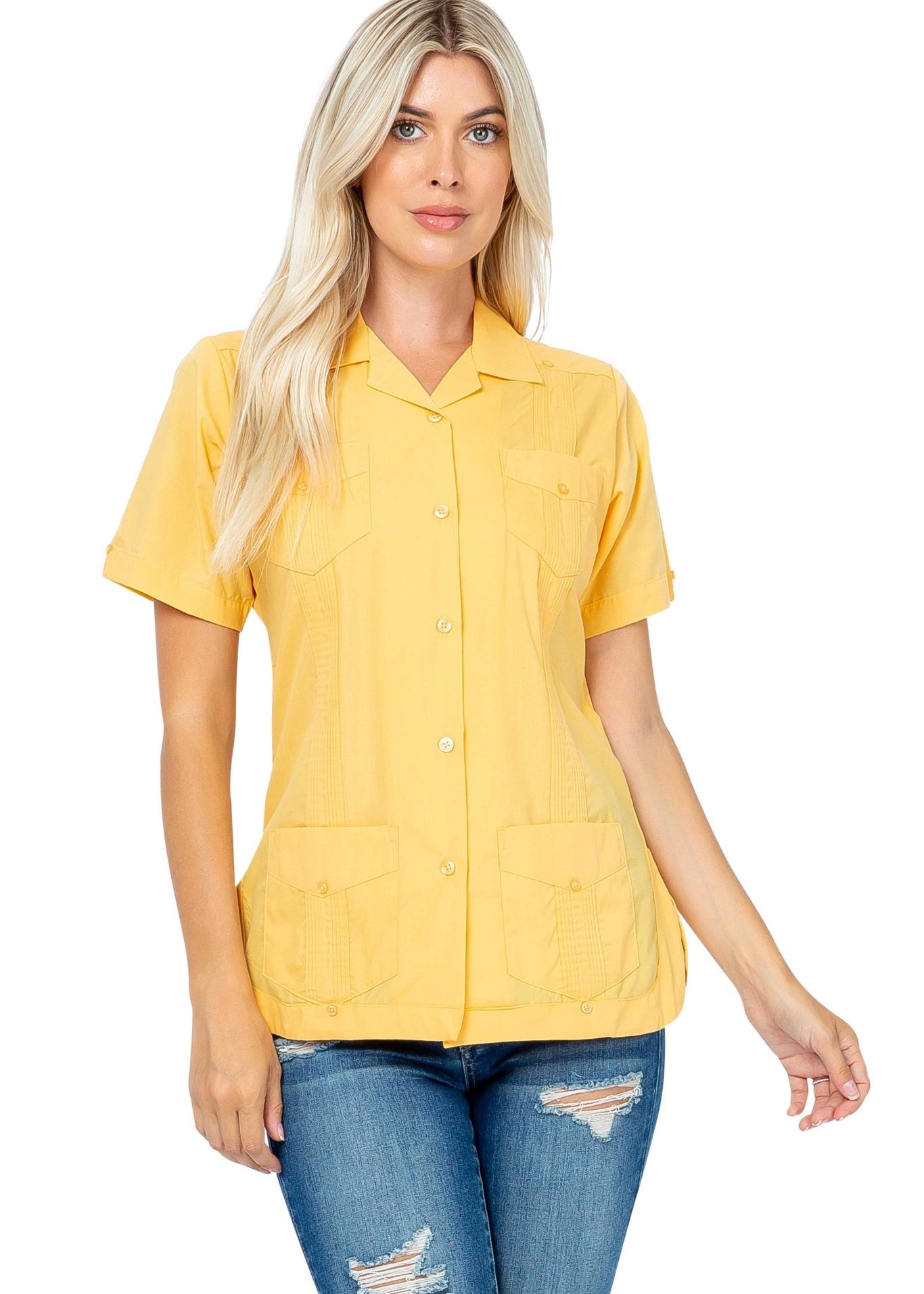 Blonde woman models a yellow Women's Short Sleeve Guayabera with 4 Pockets, buttoned and with detailed stitching.