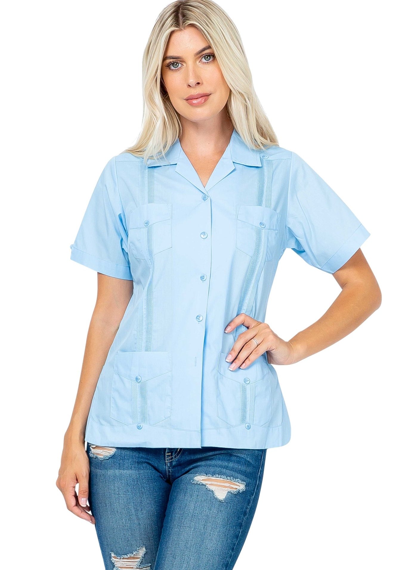 A blonde woman models a light blue Women's Short Sleeve Guayabera with 4 Pockets, shown at a front angle.