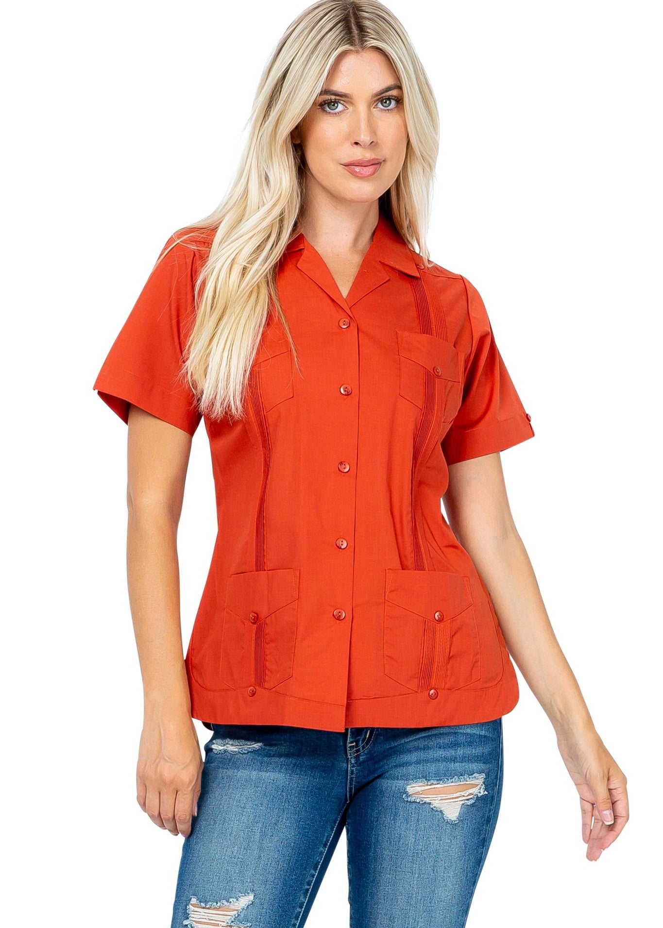 A blonde woman models an orange short sleeve women's Guayabera with 4 pockets.