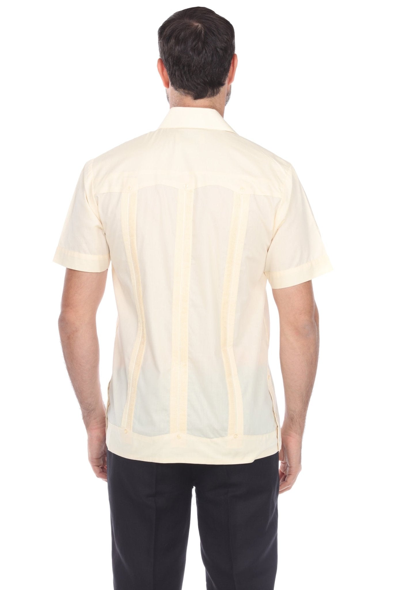 Back view of a men’s short sleeve guayabera shirt in cream, showing traditional vertical pleats and heritage embroidered accents.
