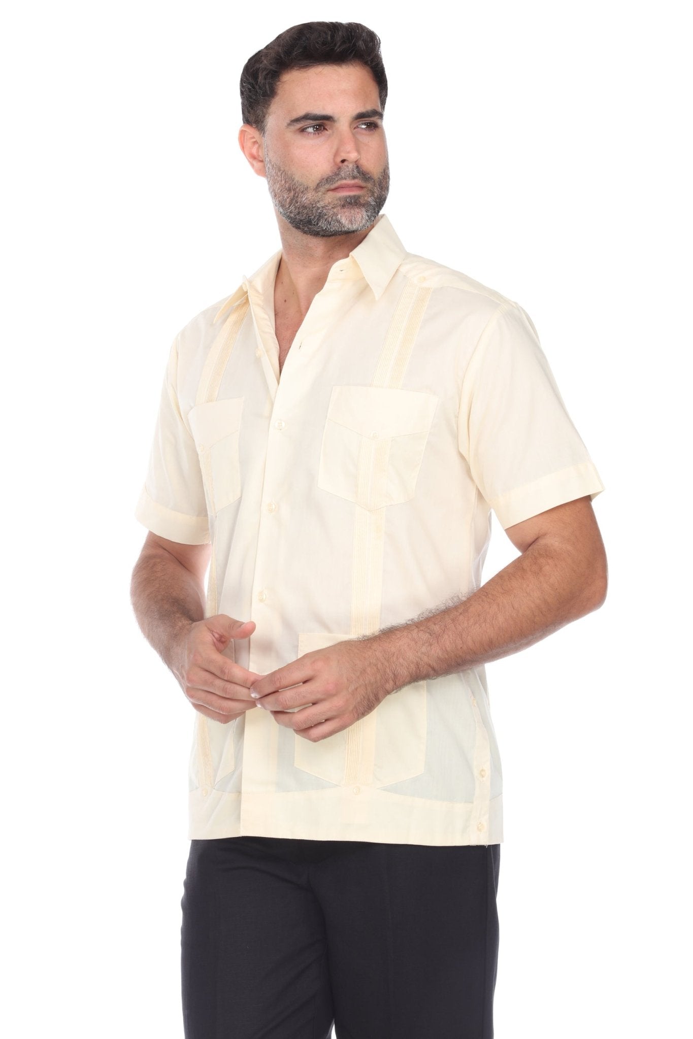 Angled front view of a classic 4-pocket cream guayabera shirt for men made from a breathable cotton-blend.