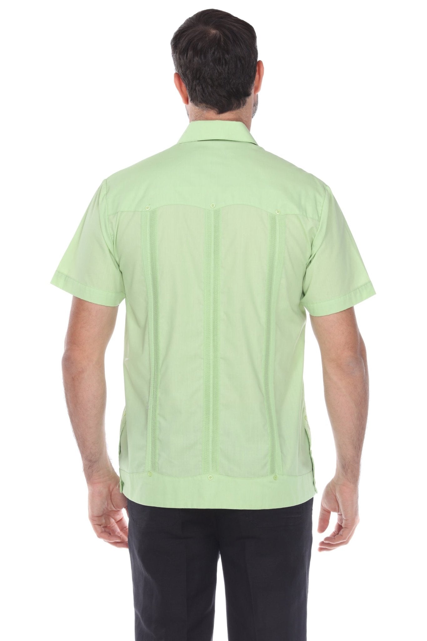 Back view of the men's light green guayabera shirt showing signature vertical pleats and breathable cotton-blend fabric.