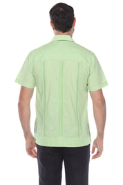 Back view of the men's light green guayabera shirt showing signature vertical pleats and breathable cotton-blend fabric.