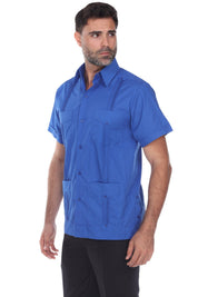 Side profile of a man wearing a blue guayabera shirt, illustrating the classic easy-wear fit ideal for tropical climates.