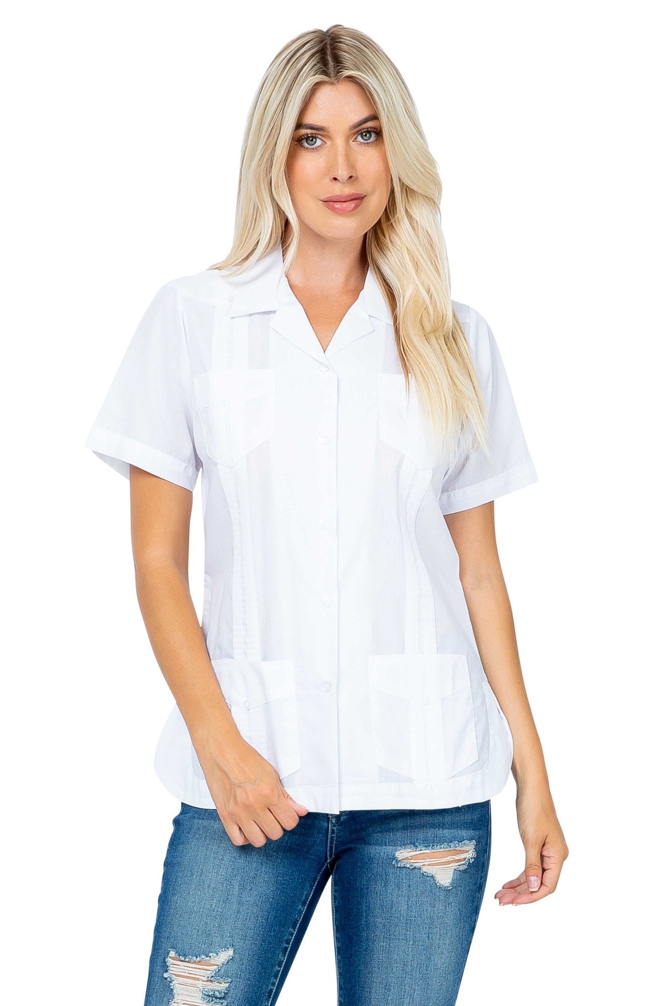 Front view of a woman wearing a white Women's Short Sleeve Guayabera with 4 Pockets and blue jeans.