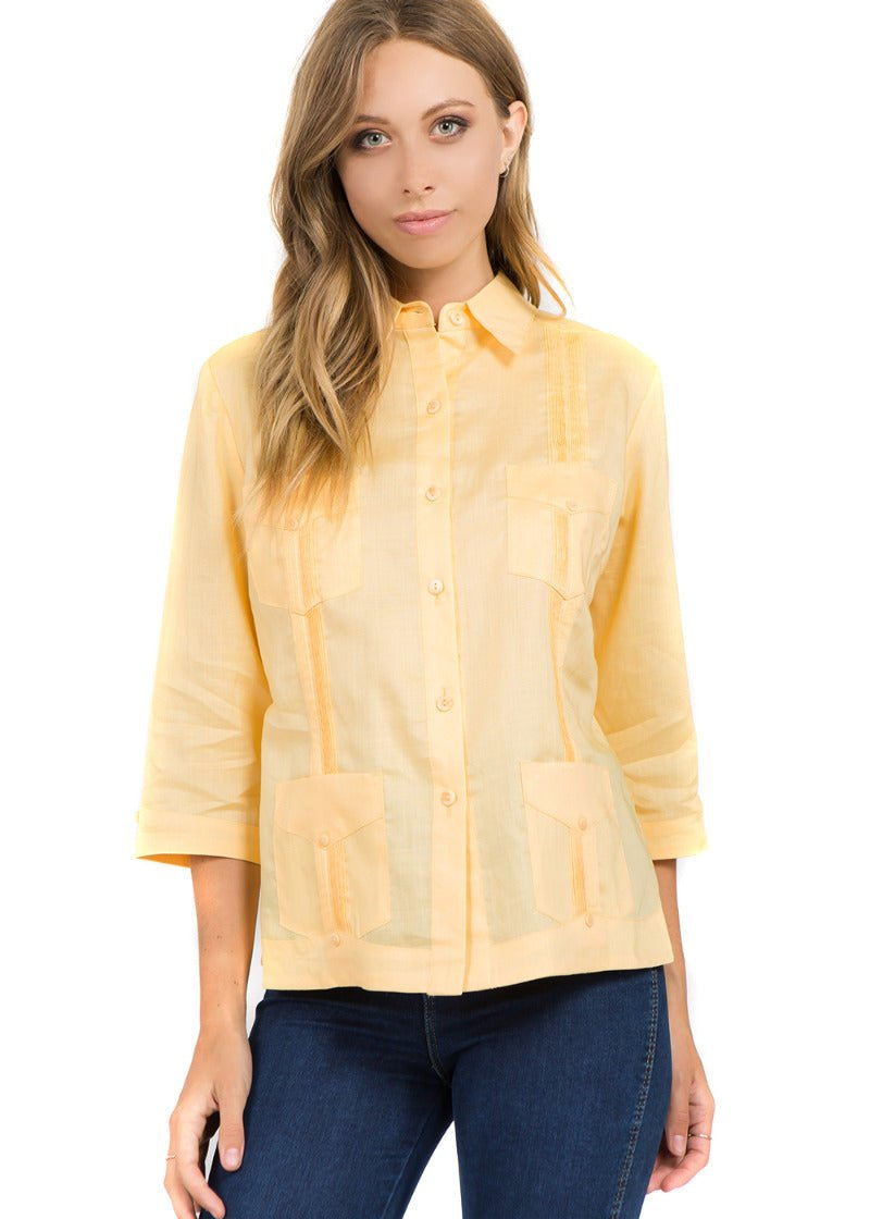 Front view of the pale yellow 100% linen guayabera shirt showing classic pleats and authentic four-pocket construction.